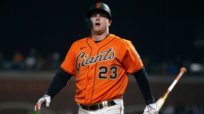 Giants designated hitter Joc Pederson (23) walks back to the dugout after striking out.